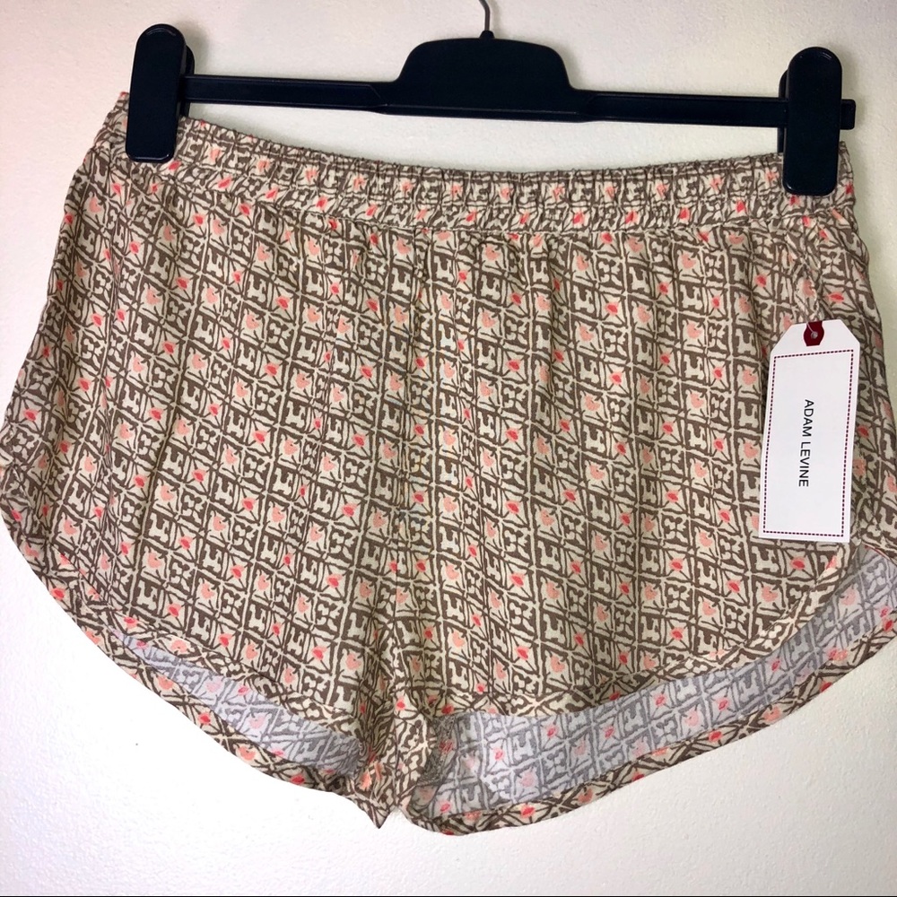 Tan shorts with peach/pink designs